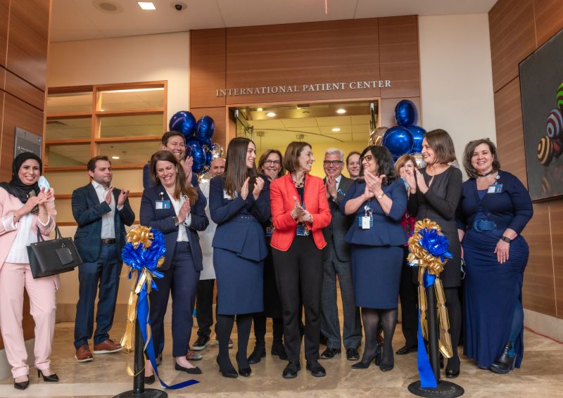 Staff from the International Patient Center (IPC) at Dana-Farber share a moment of joy after Laurie H. Glimcher ceremoniously cut a blue ribbon to mark its official opening on Jan. 16 – Dana-Farber Cancer Institute