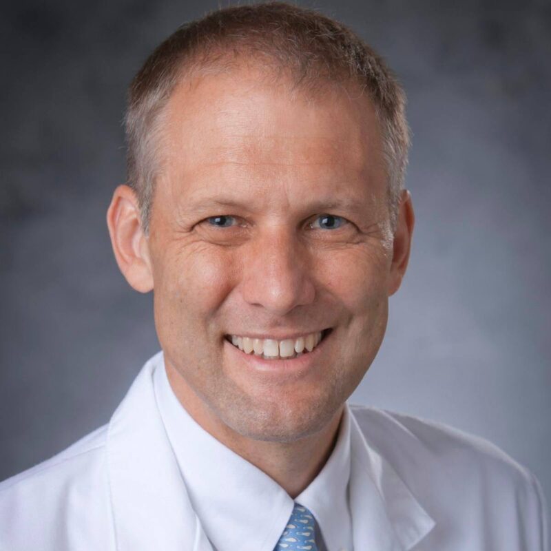 Tom Stinchcombe, MD, FASCO
Dr. Stinchcombe specializes in lung cancer clinical trials and multidisciplinary care innovations. He has held leadership roles in cooperative oncology organizations and mentorship programs.