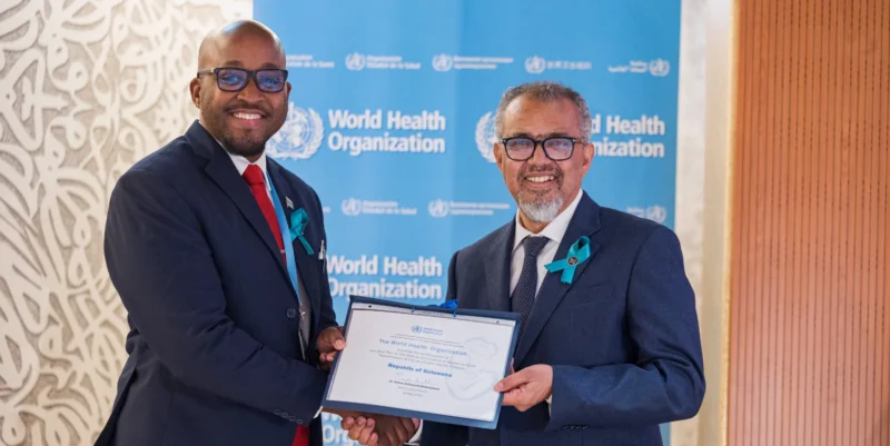 The Minister of Health of Botswana Dr. Stephen Modise receives a certificate from WHO Director-General Dr Tedros Adhanom Ghebreyesus